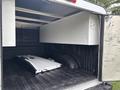 A 2020 Ford F-150 truck bed featuring a large storage box on one side and a metal component lying flat on the bed floor