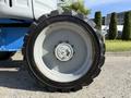 Close-up of a tire on a 2012 Genie Z 45/25 aerial lift showing rugged treads and a steel hub with a center bolt and cap