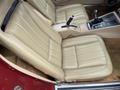 Tan leather seats of a 1970 Chevrolet Corvette with a gear shifter and a central console visible in the foreground