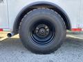 A close-up of a large black tire mounted on a 2006 Freightliner M2 106 with a sturdy rim and visible tread pattern