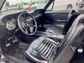 Interior of a 1968 Ford Mustang Two Door Convertible featuring black leather seats a steering wheel and a dashboard with dials and controls