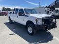 2016 Ford F-350 SD pickup truck with a crew cab a utility grille guard and off-road tires in a white finish