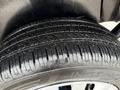 Close-up of a tire from a 2017 RAM ProMaster City showing detailed tread patterns and wet surface on the rubber