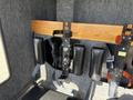 A 1994 Volvo FE 42 featuring a set of black leather seat belts mounted on a wooden panel with numbered labels