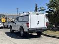 White 2019 Ford F-150 with a truck bed cover parked on a street