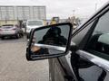 Close-up of the side mirror of a 2016 Mercedes-Benz GLA-250 with water droplets indicating recent rain
