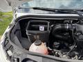 2022 Mercedes-Benz Sprinter engine compartment showing a black air filter box and various engine components including a coolant reservoir and hoses