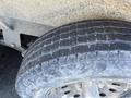 Close-up of a worn tire on a 2015 Snake Trailer showing significant tread wear and dirt on the surface