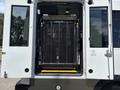 A 2020 Chevrolet Express with an open rear entry showcasing a wheelchair lift in a folded position and a ramp extending from the vehicle's interior