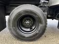 Close-up of a large black tire mounted on a 2015 Freightliner M2 with metal rim and unique tread pattern