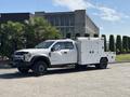 A white 2017 Ford F-550 truck with a utility body and multiple compartments for tools and equipment