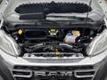 The hood of a 2023 RAM Promaster 3500 is open revealing the engine compartment with various components including coolant reservoir and battery