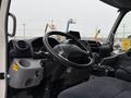 Interior view of a 2015 Hino 195 truck featuring a steering wheel dashboard controls and seating area