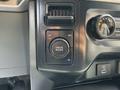 A control panel in a 2021 Ford F-150 featuring a drive mode selector with settings for 2H 4H and 4L
