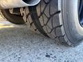 Close-up of a treaded tire from a 2006 Freightliner M2 106 showing deep grooves and rugged surface for traction
