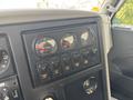 Dashboard of a 2013 International WorkStar showing gauges for axle pressure and various control switches