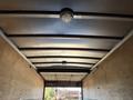 Interior view of a Freightliner M2 106 truck showing the roof structure with metal beams and a ceiling light