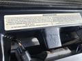 A label attached to a 2015 Ford F-550 engine indicating modifications and warranty information