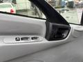 Close-up of the driver's side door panel of a 2015 Hino 195 featuring window controls and a door handle