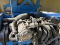 A close-up view of the engine compartment of a 2012 Genie Z 45/25 with visible engine components and connected hoses