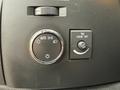 A close-up of the dashboard controls in a 2013 Chevrolet Silverado 3500HD featuring a dial for auto headlights and a switch for dome light off