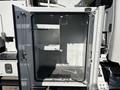 An open storage compartment of a 2019 Freightliner M2 106 with shelves and hooks inside