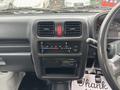 Dashboard of a 2008 Suzuki Carry featuring air conditioning controls a digital clock and a car radio display