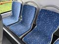 Three blue fabric bus seats with a star-patterned design arranged in a row