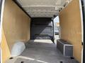 2021 Mercedes-Benz Sprinter cargo van interior showing empty space with wooden panels on sides and a small black box on the floor