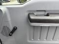 Close-up of the interior door handle and window control of a 2018 Ford F-750 showcasing a textured gray panel and a lever for window operation