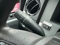 Close-up of a 2015 Ford F-450 steering column featuring a turn signal stalk with controls for headlights and wipers along with a textured steering wheel