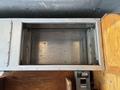 An empty metal compartment inside a 2011 Workhorse W62 with a smooth interior surface and metal seams