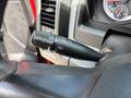 A close-up of the steering column controls in a 2013 RAM 2500 featuring the windshield wiper control stalk with settings for mist and low/high speeds