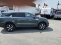 A 2022 Kia Sorento parked with its profile visible featuring a green exterior and alloy wheels