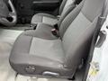 The image shows the front seats of a 2012 GMC Canyon with dark fabric upholstery and light gray patterned inserts