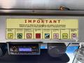 A 2012 Ford Econoline dashboard featuring a yellow sign with important safety policies for employees and a radio console below it