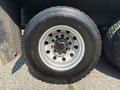 Front wheel of a 2008 Peterbilt 340 featuring a silver rim with multiple bolts and a black tire labeled with the brand name and size