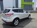 A 2015 Ford Escape in silver color parked at an angle showing the rear and side view with five doors and five-spoke wheels