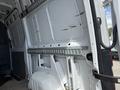 Interior view of a 2016 Mercedes-Benz Sprinter showing the empty cargo area with side walls and a metal track for securing cargo