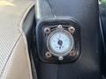 A gauge mounted on a panel indicating fuel levels with markings for empty half full and full on a 2021 John Deere 1575