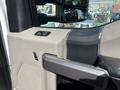 Close-up of the interior door handle and control panel of a 2019 Ford F-550 with a textured surface and buttons for windows and mirrors