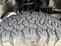 Close-up of a rugged tire tread from a 2013 RAM 2500 showcasing deep grooves and a heavy-duty design for traction and durability