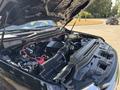 A 2022 Ford F-350 SD truck with the hood open showing the engine compartment including various mechanical components and wiring