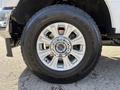 A close-up of the wheel and tire of a 2021 Ford F-250 SD featuring a silver alloy rim with a Goodyear Wrangler tire