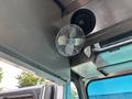 A metallic ceiling fan mounted in a vehicle interior with a silver finish and a grid design