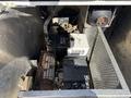 A 2024 Ford F-550 engine compartment showing various components including motors wires and a ventilation fan