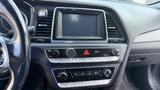 Interior dashboard of a 2018 Hyundai Sonata featuring a touchscreen display and various control buttons for audio and climate settings