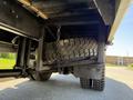 A 2009 International 3000 CE bus with a visible spare tire secured by a chain mounted beneath the vehicle