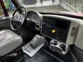 Interior of a 2011 International 4400 showing a steering wheel dashboard controls and gear shift with a cup holder