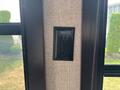 A black electrical outlet mounted on a wall inside a 2021 Jayco Jay Flight camper